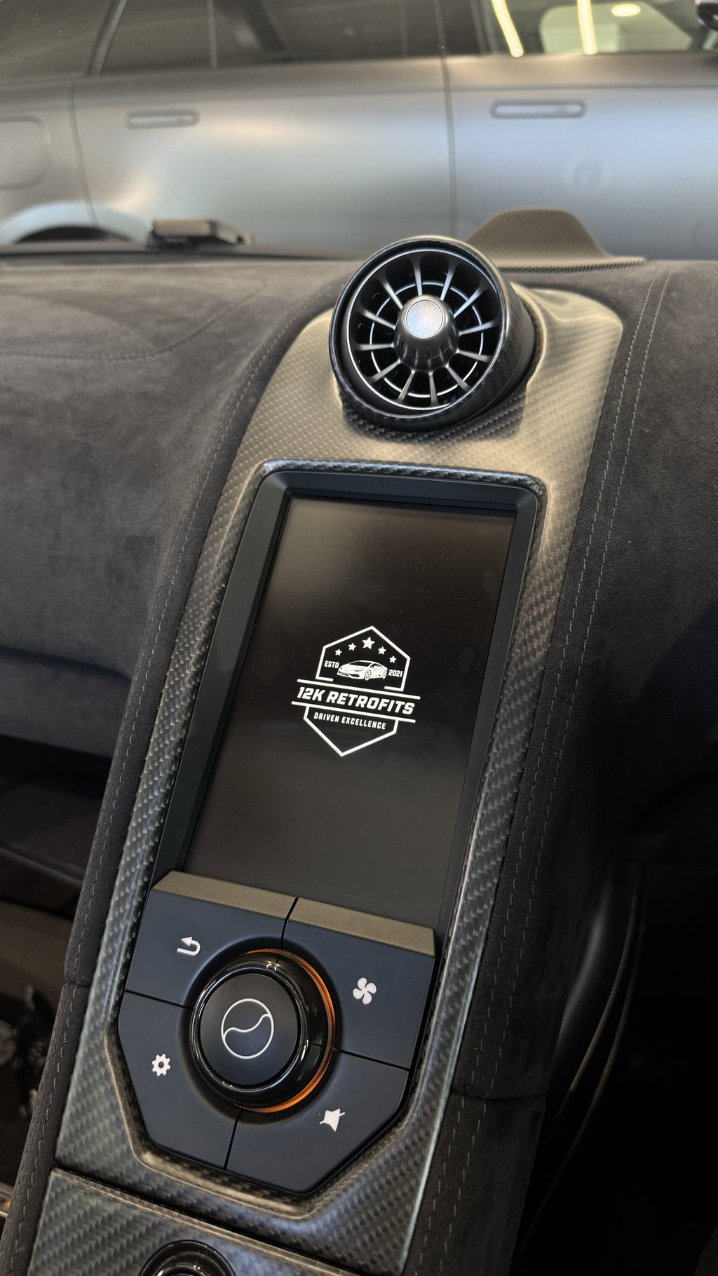 12K Retrofits start-up screen on the IRIS display of a McLaren 675LT