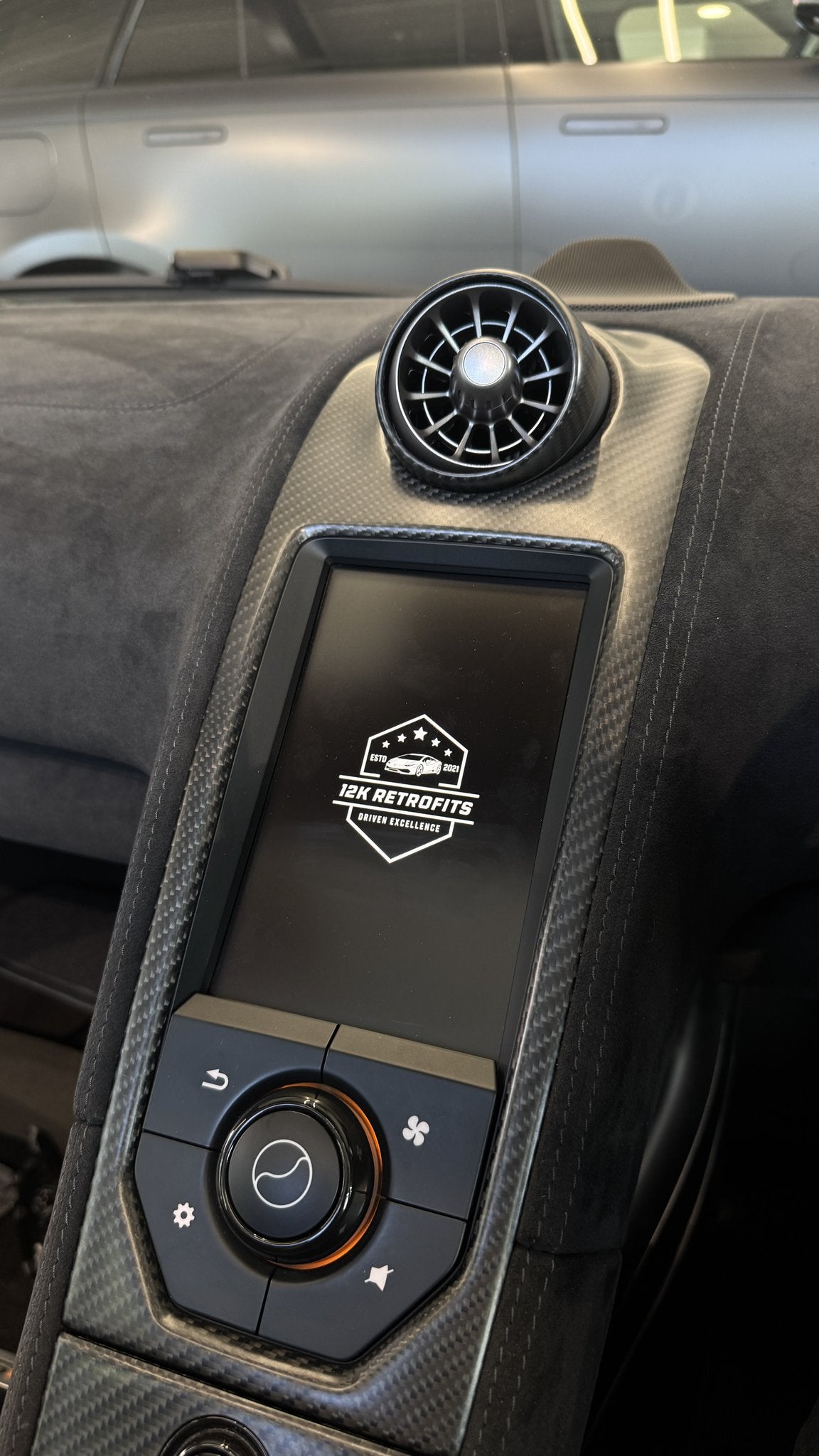 12K Retrofits start-up screen on the IRIS display of a McLaren 675LT