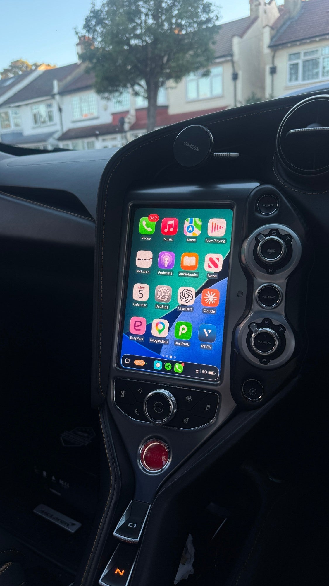 Apple CarPlay home screen on the portrait centre screen of a McLaren 765LT